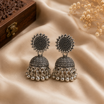 Beautiful pair of oxidised silver jhumka earrings with an intricate dome design.