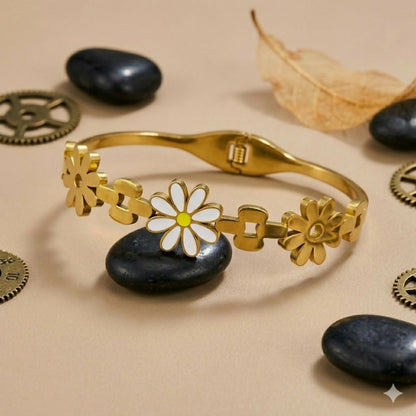 Close-up of gold-tone flower details with enamel centers