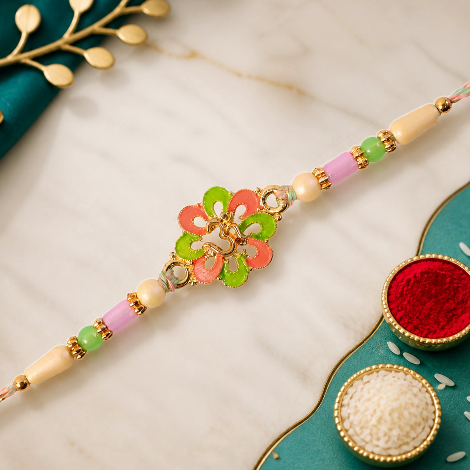 Om Flower Pendant Rakhi with Coral and Green Enamel