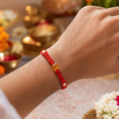 Red Thread Rakhi with a Faceted Amber-Toned Crystal Cube Bead