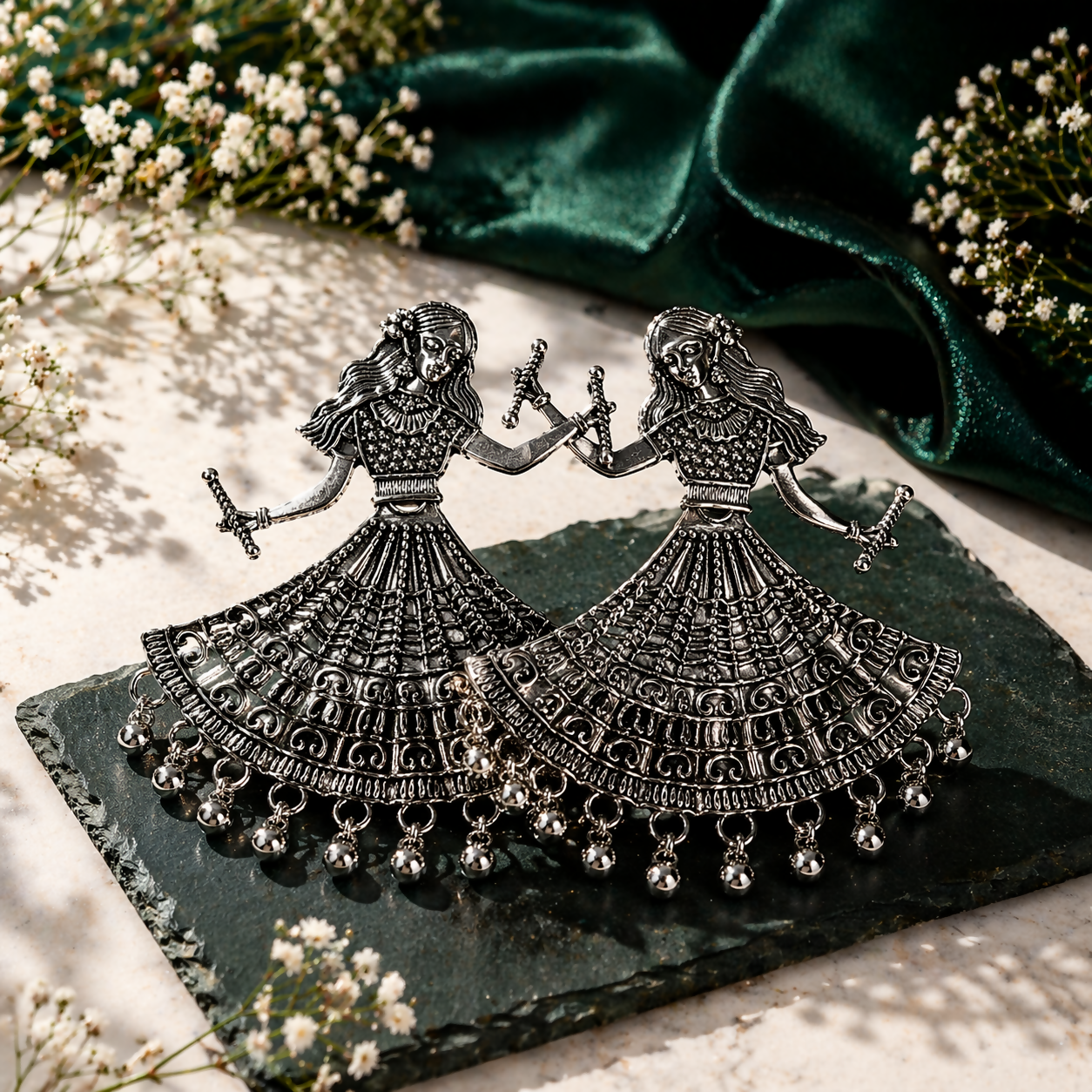 Close-up of intricate ethnic carvings on oxidized silver Dandiya earrings