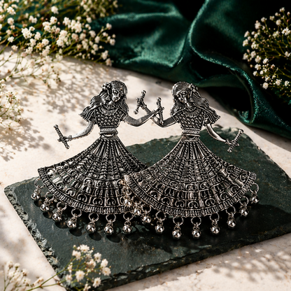 Close-up of intricate ethnic carvings on oxidized silver Dandiya earrings
