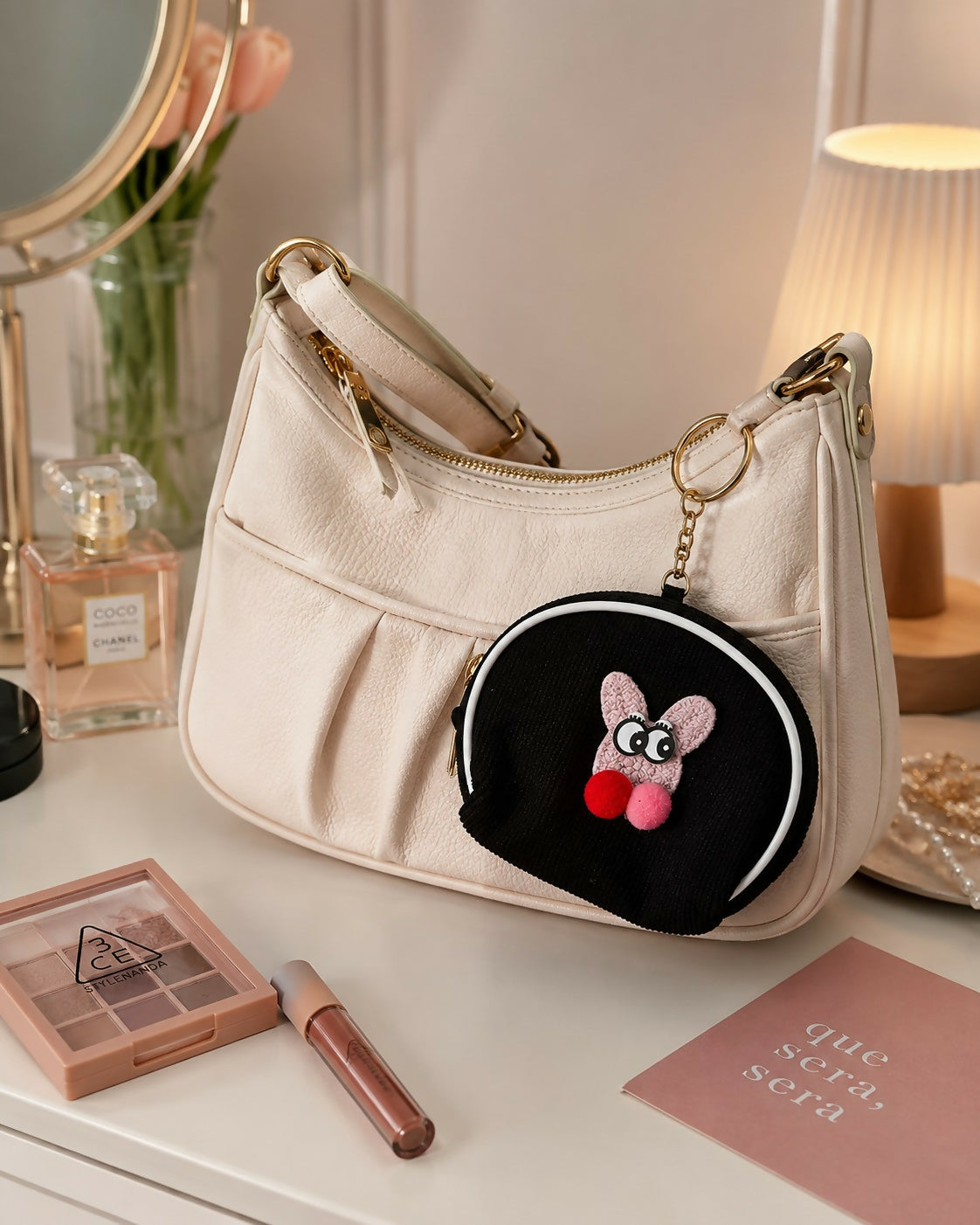 Mini coin pouch keychain clipped to handbag strap
