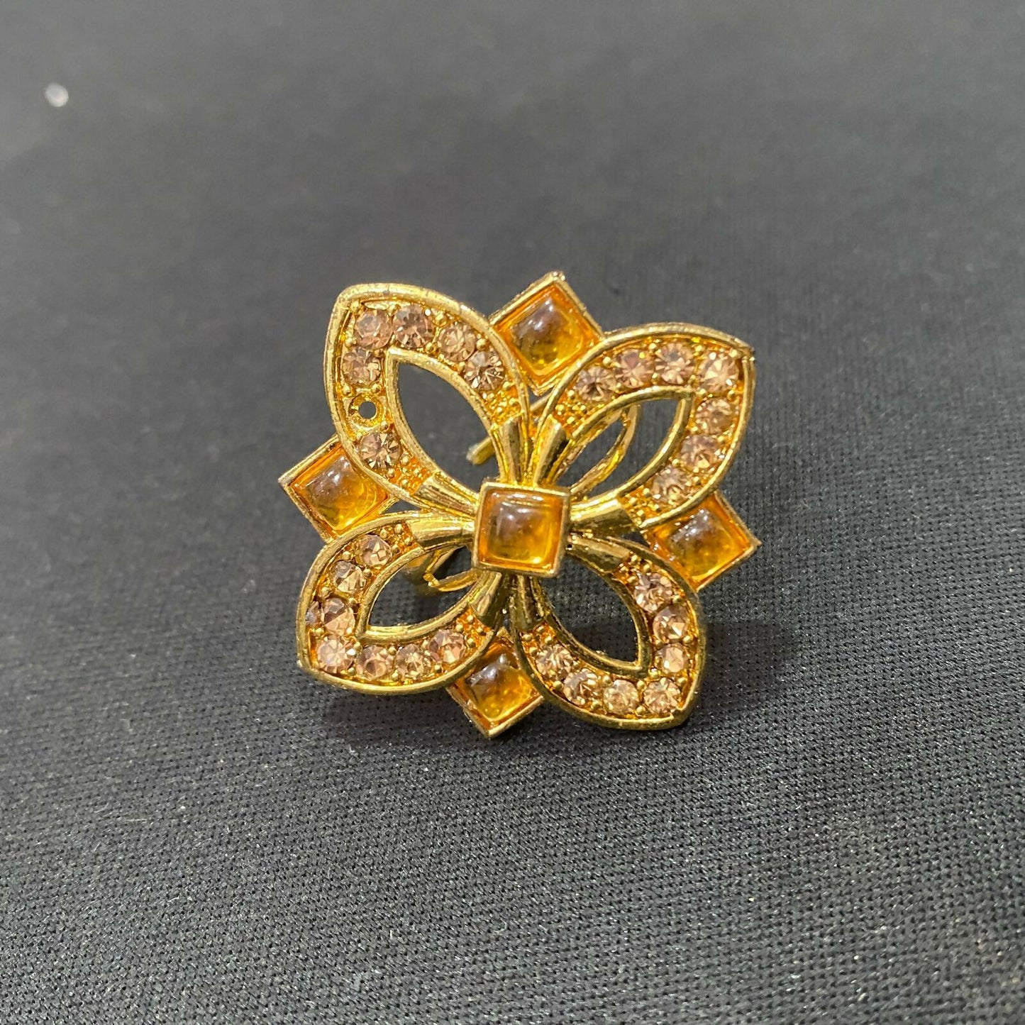 Stylish gold finish adjustable ring adorned with floral crystals.