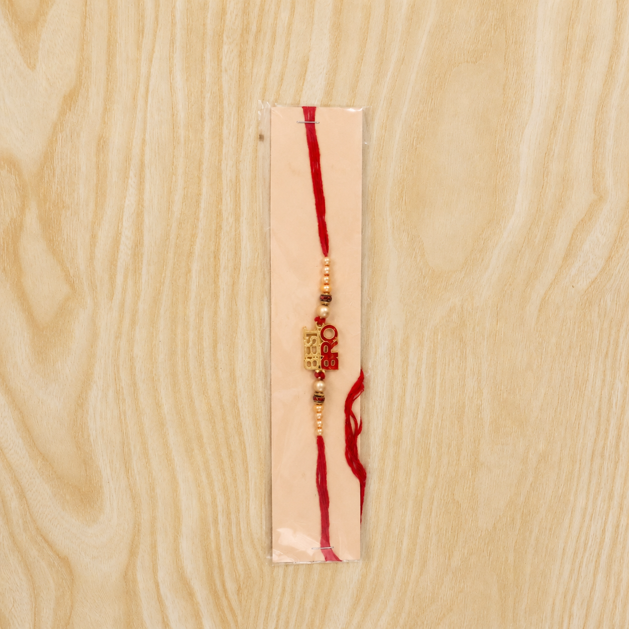 Best Bro Text Rakhi with Gold Letters and Neat Pearl Beads