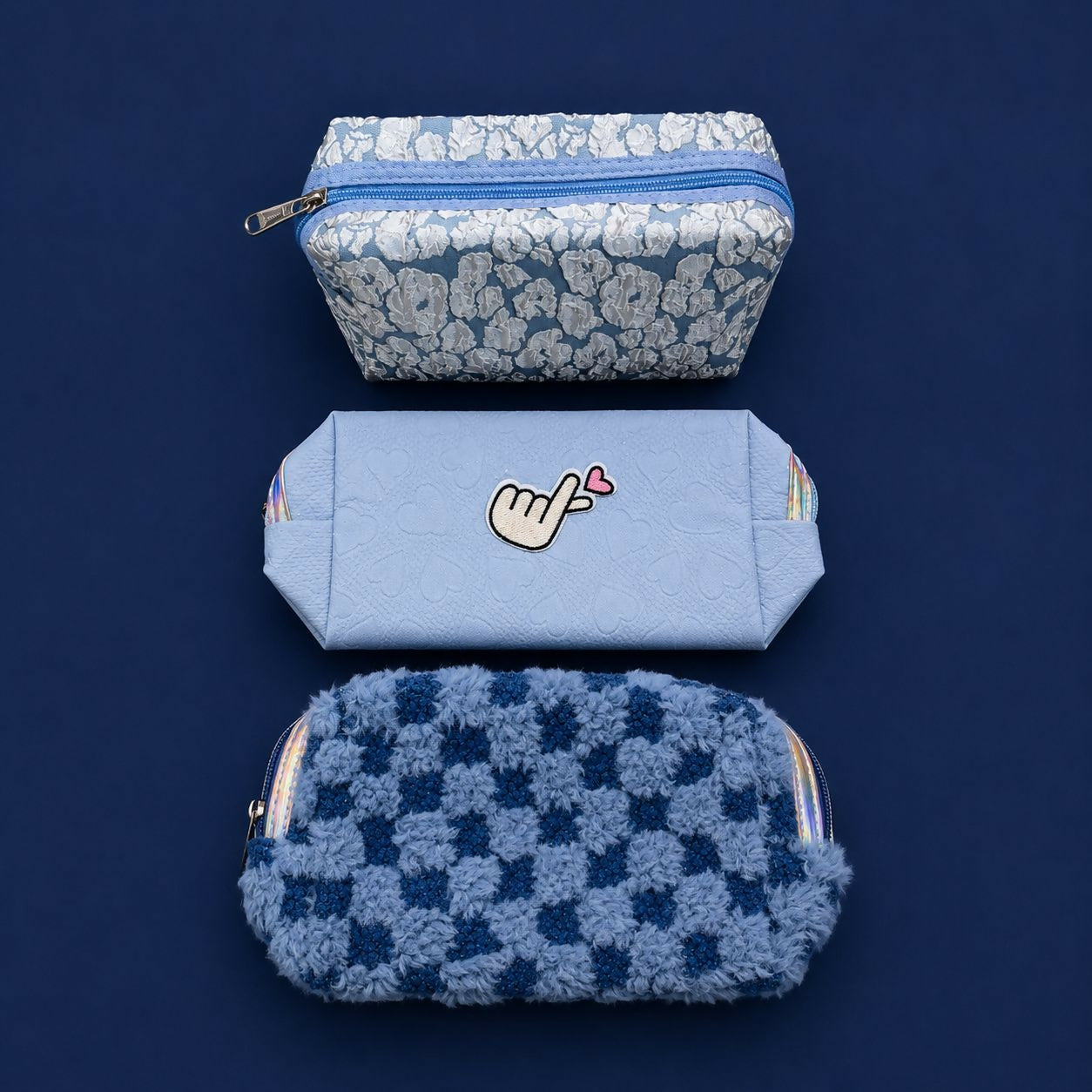 Embroidery detail on pastel zipper organizer pouch