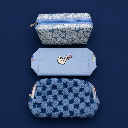 Embroidery detail on pastel zipper organizer pouch