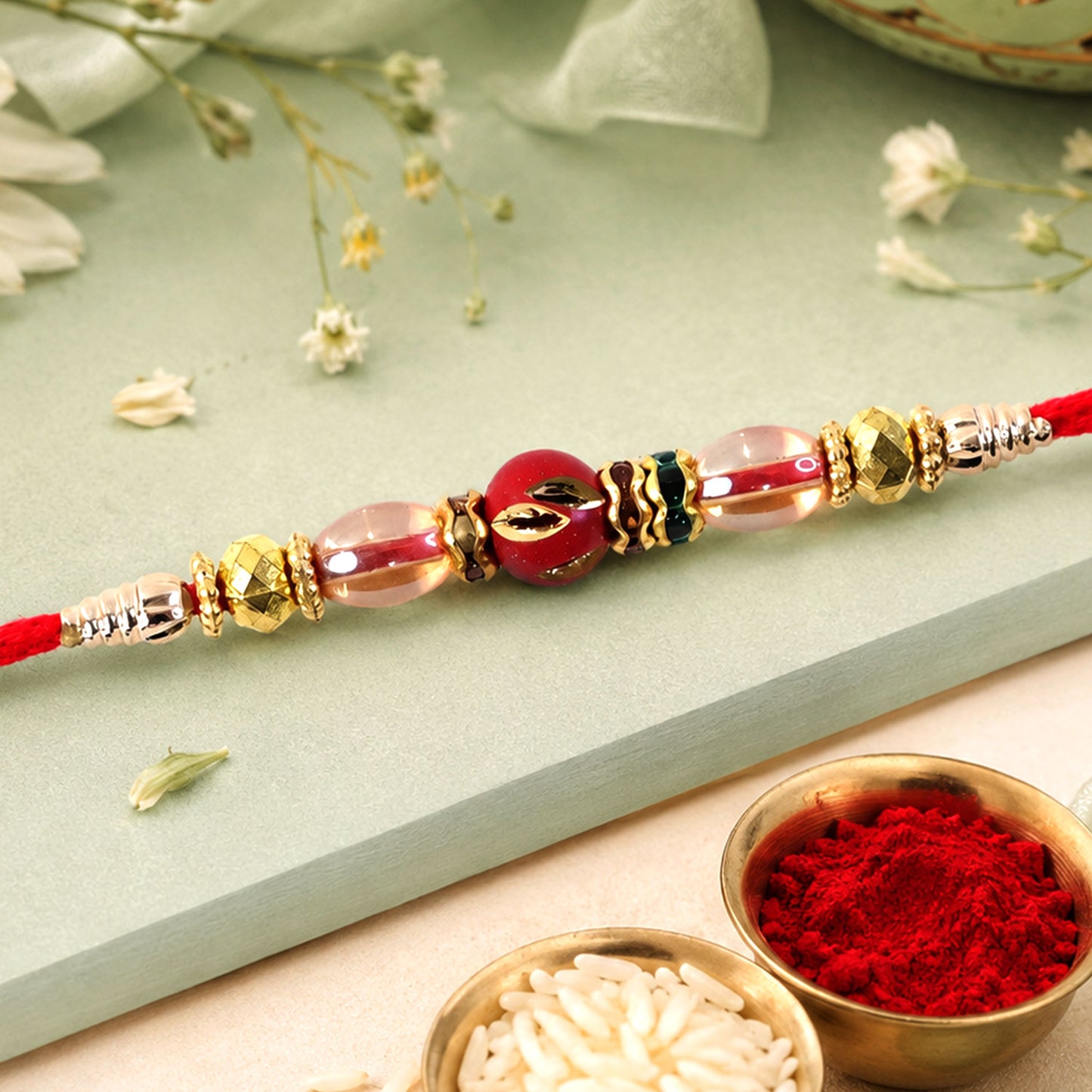 Red Enamel Golden Designer Rakhi with Transparent Beads and Rich Festive Shine