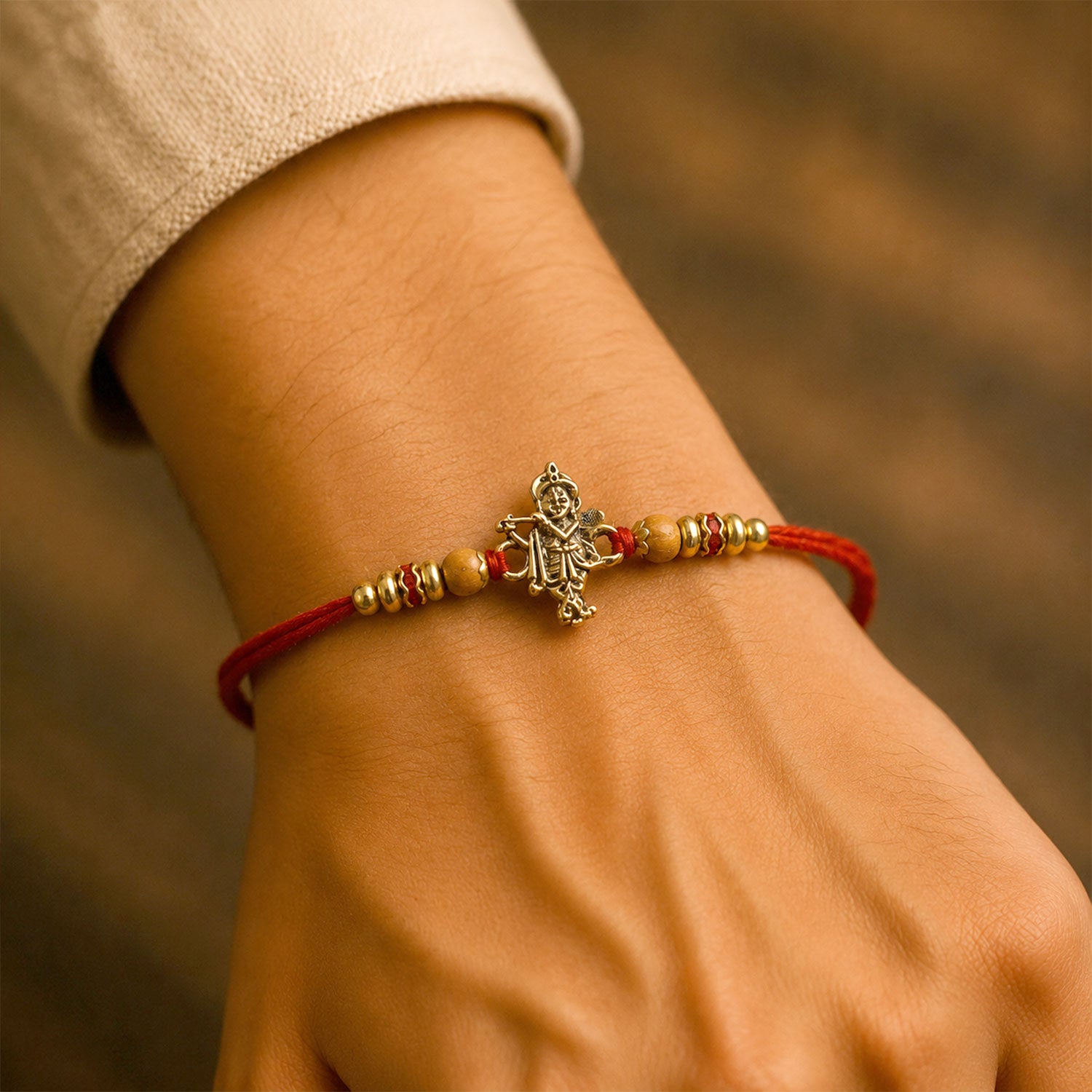 Krishna Flute Idol Devotional Rakhi with Golden Centre, Wooden Beads and Red Thread