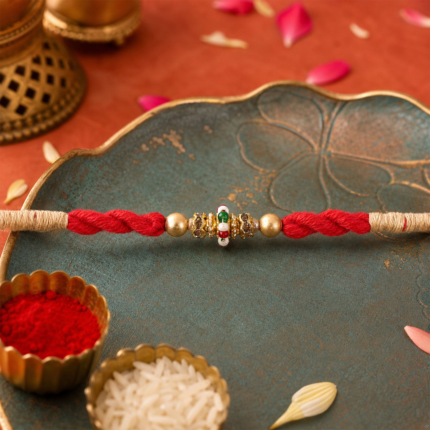 Red Twisted Cord Rakhi with a Colourful Enamel Bead and Gold Accents