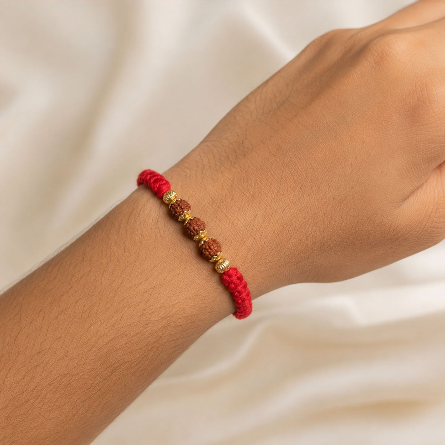 Red Braided Rakhi with Rudraksha Beads and Golden Bead Accents