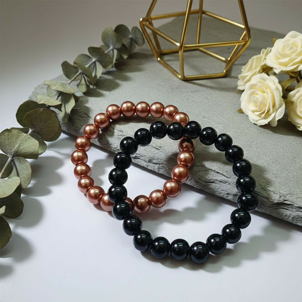 Close-up of black beads and gold accents on bracelet