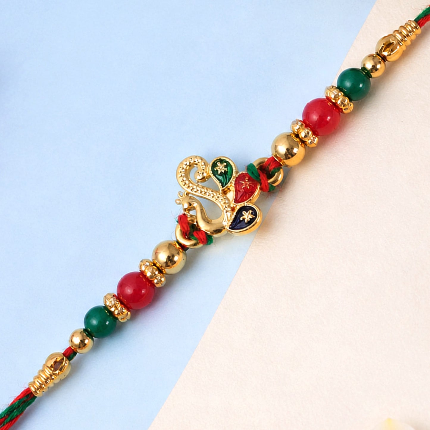 Colorful Enamel Peacock Pendant Rakhi with Red and Green Beads