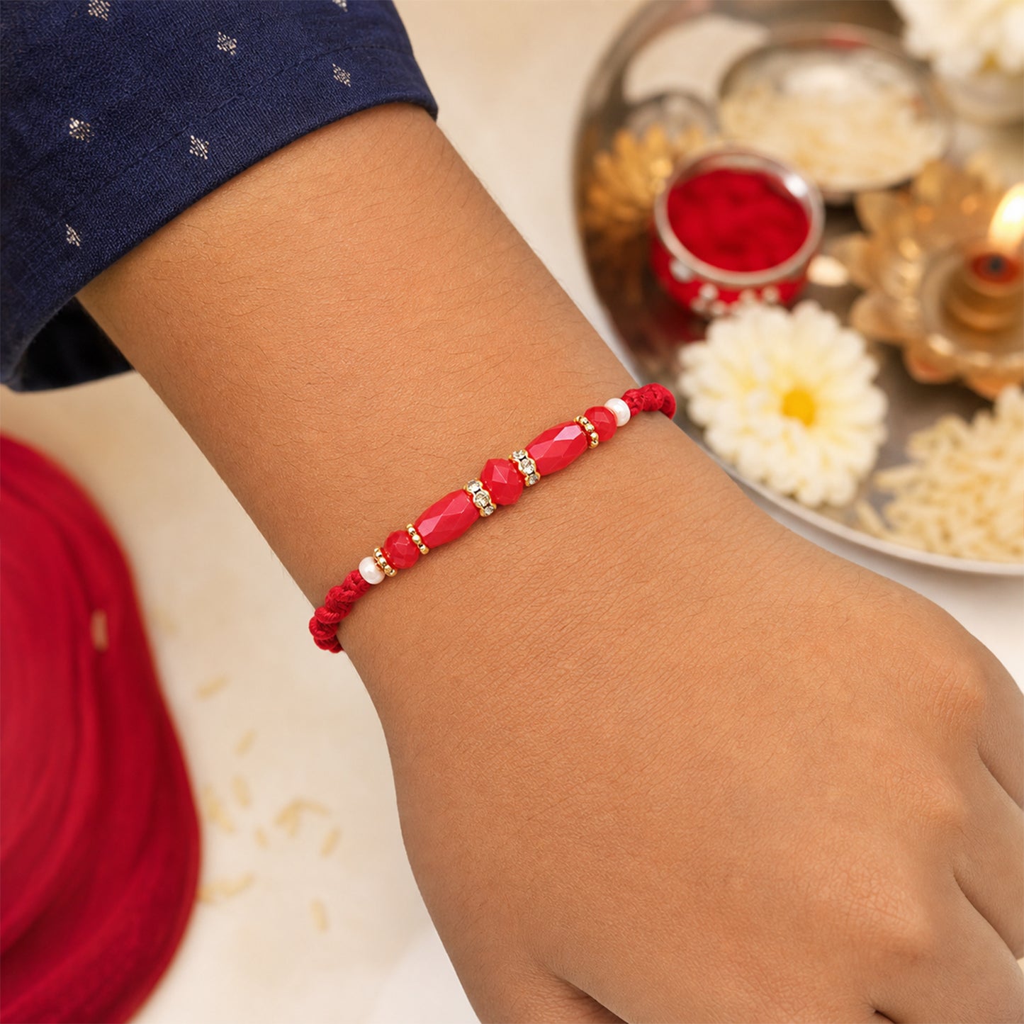 White Thread Rakhi with Smooth Red Oval Bead Accents