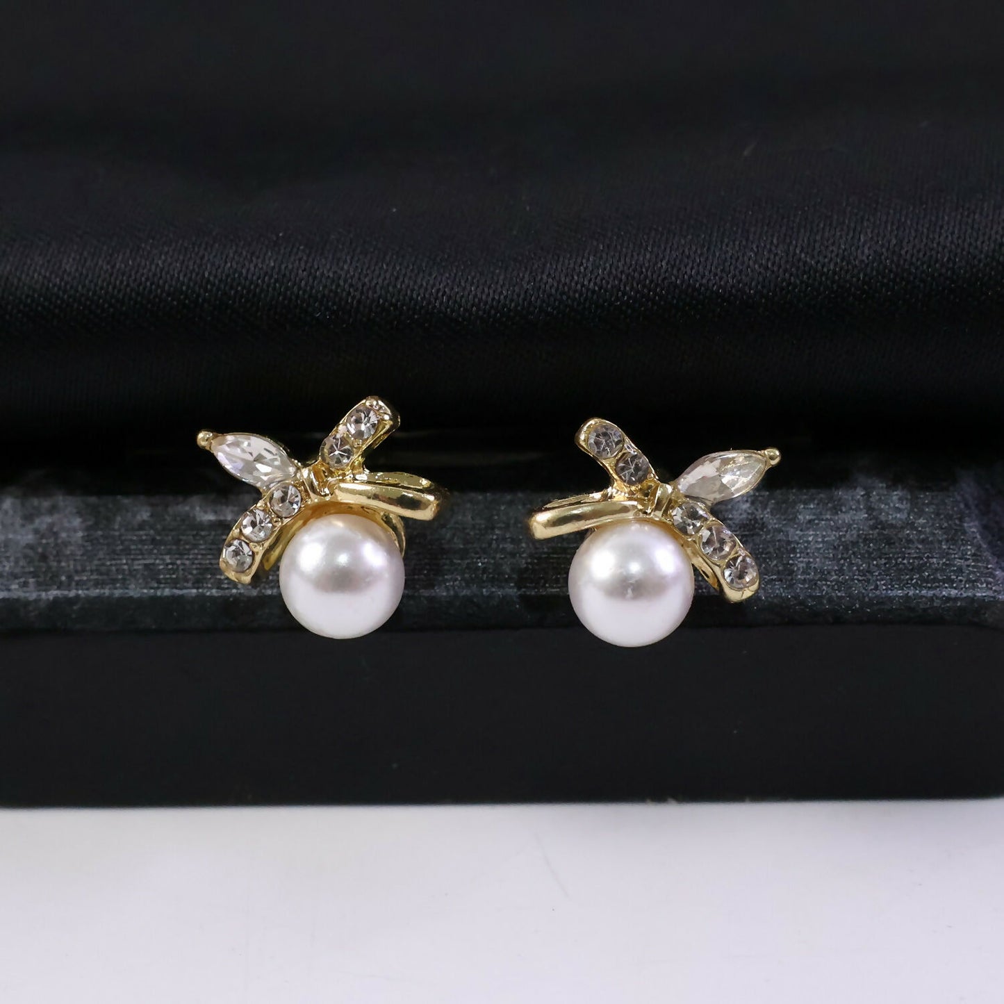 Elegant butterfly stud earrings featuring pearls and sparkling stones