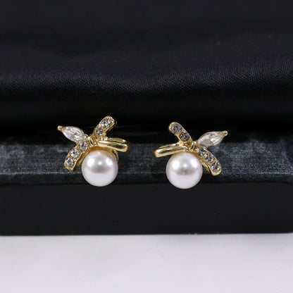 Elegant butterfly stud earrings featuring pearls and sparkling stones