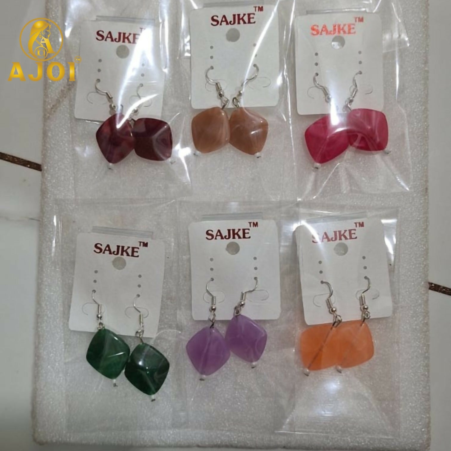 Deep red stone geometric drop earrings on display