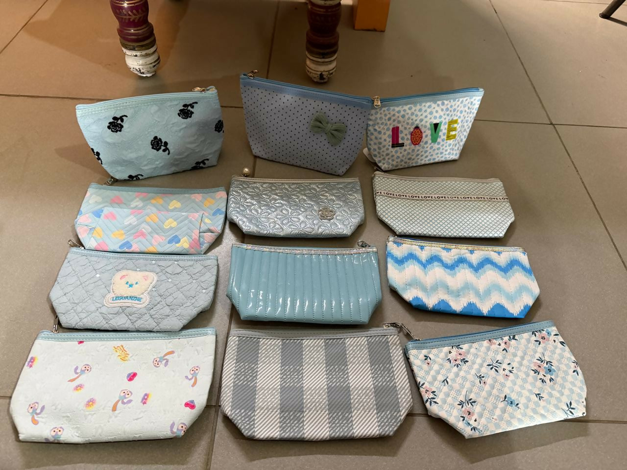 Blue multipurpose organizer pouch with stationery and makeup items inside