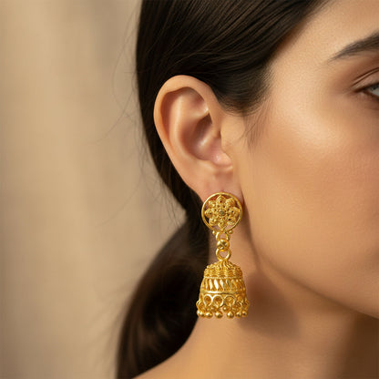 Close-up of intricate detailing on gold floral jhumka earrings