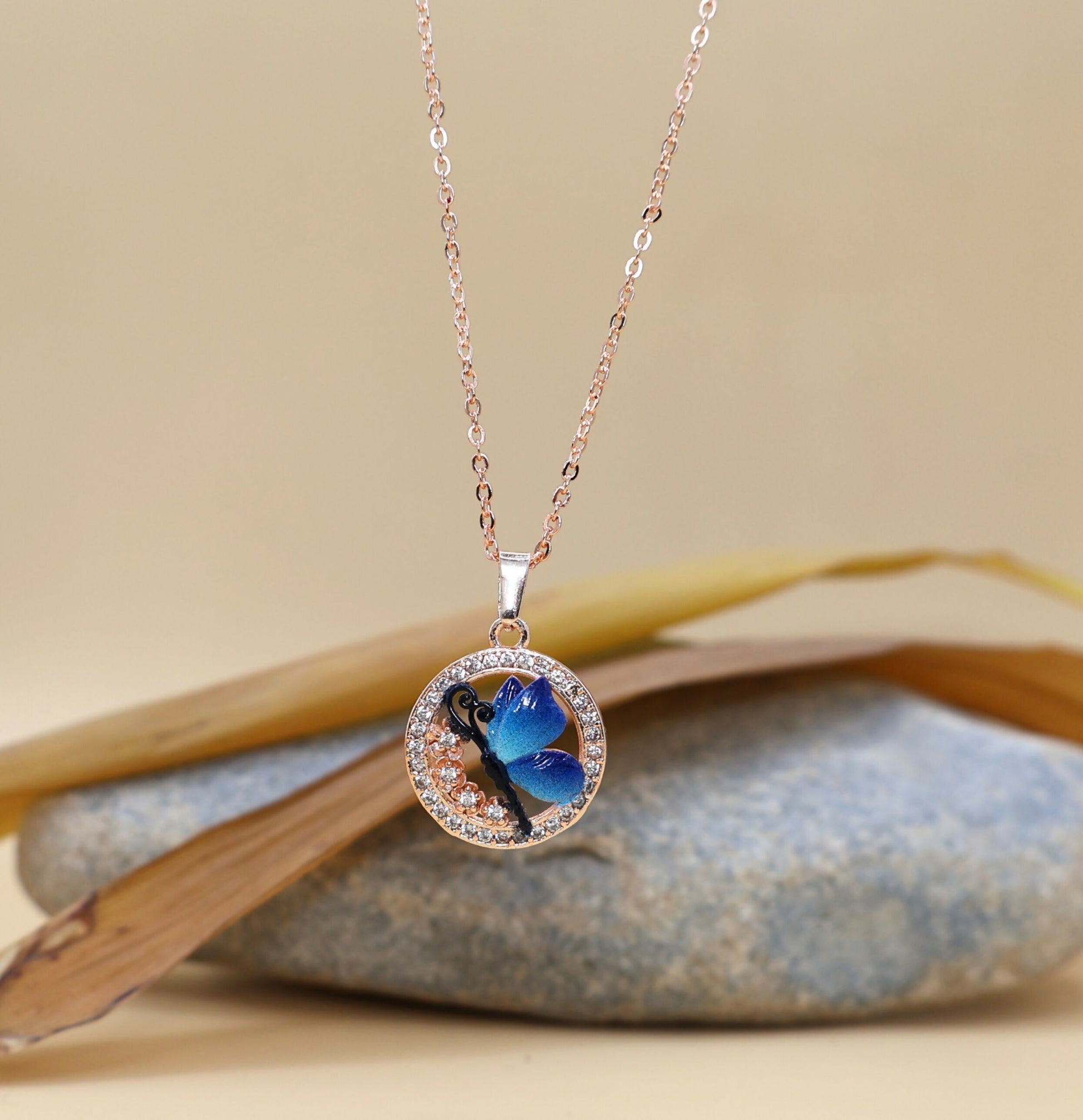 Close-up of blue enamel butterfly and sparkling Cubic Zirconia stones pendant