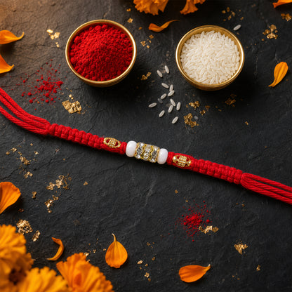 Red Braided Rakhi with White Beads and Antique Gold Accent Charms