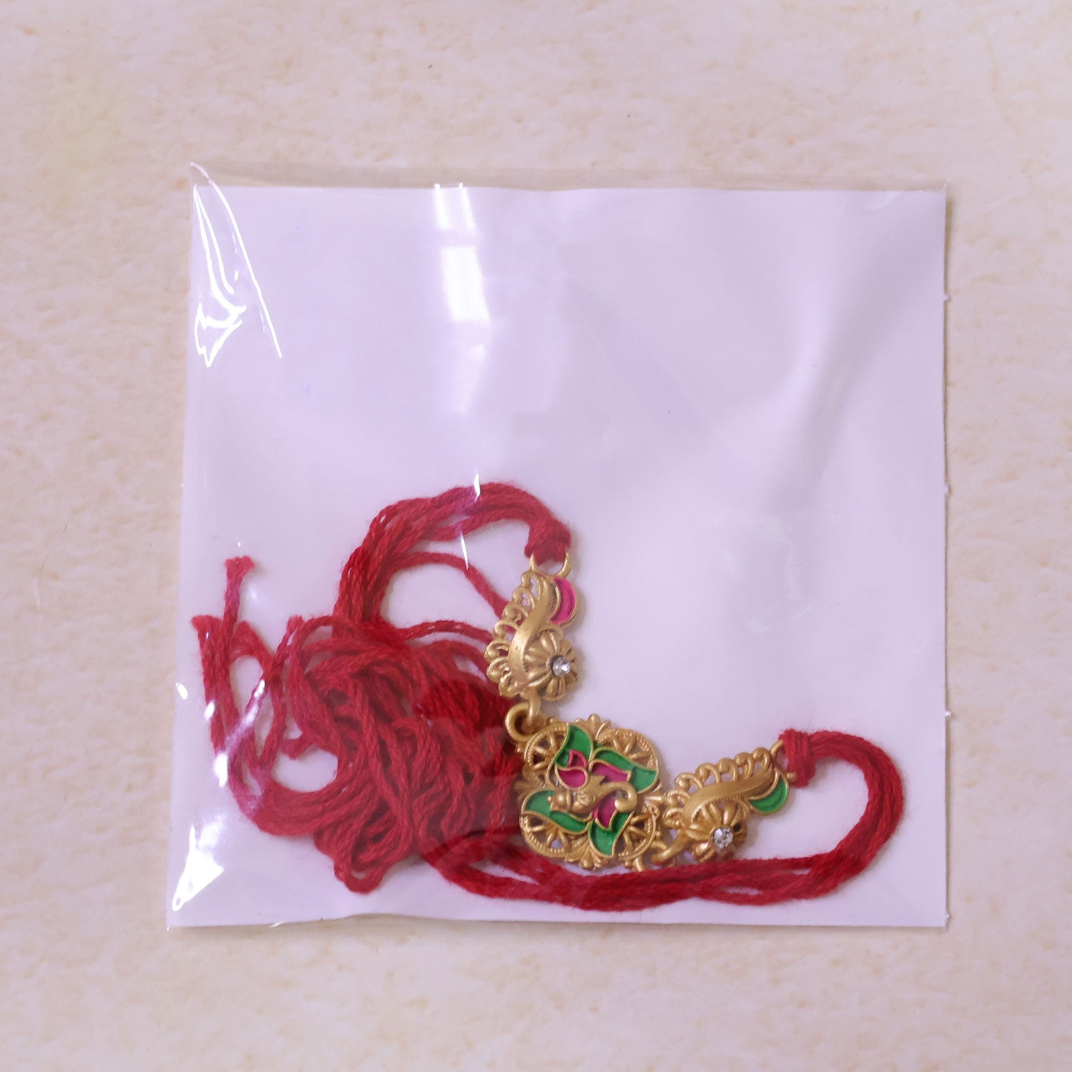Premium Rakhi showcasing Floral Medallion, crystal accents and chain look for Gift