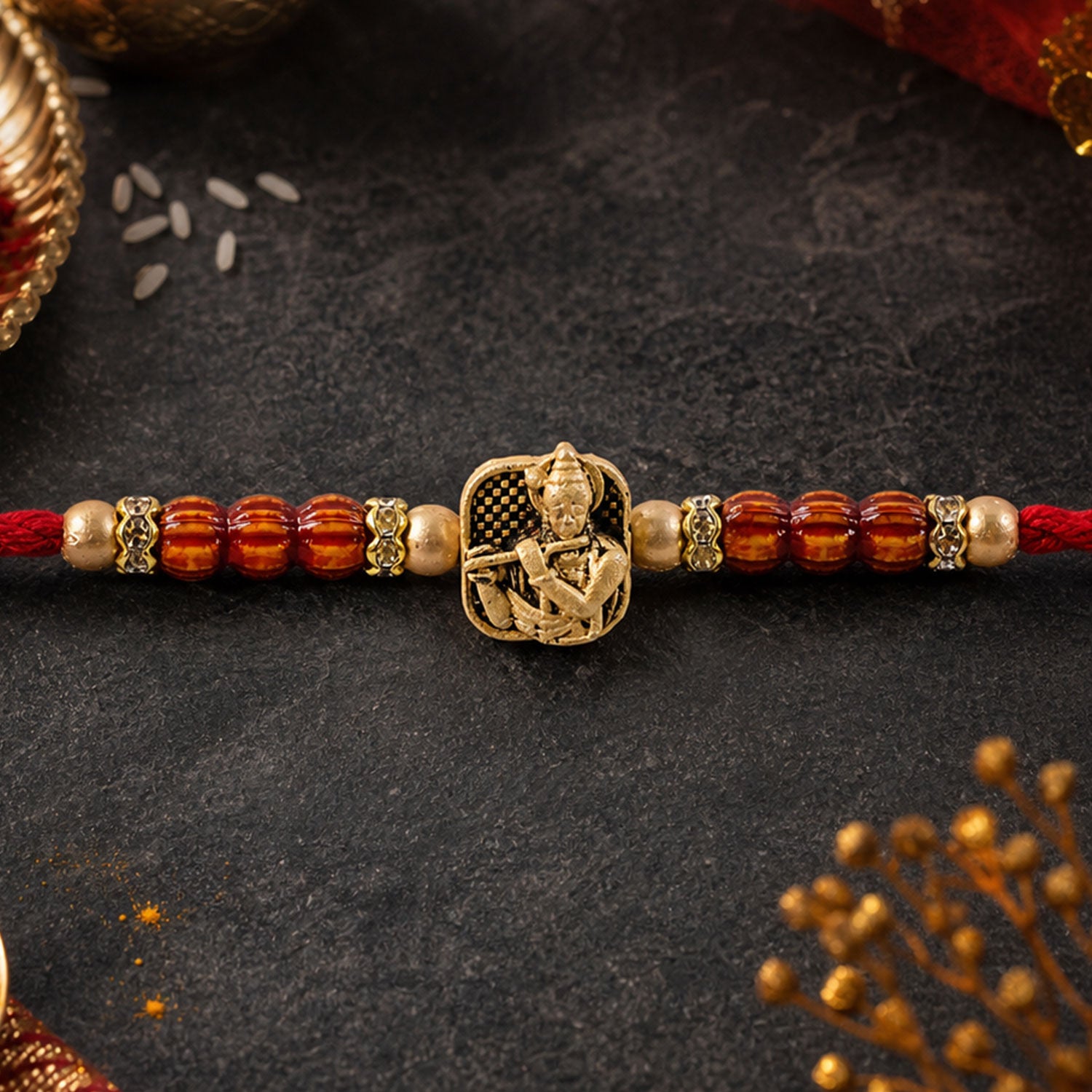 Red Beaded Rakhi with Antique Gold Krishna Charm and Wooden Beads