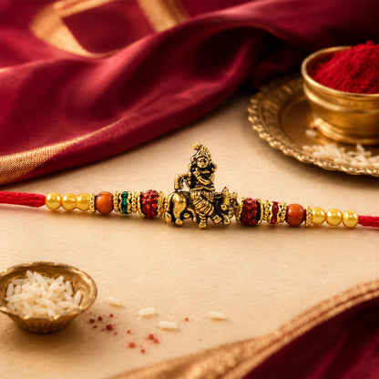 Bal Krishna Golden Devotional Rakhi with Idol Centre, Red Beads and Pearl Accents