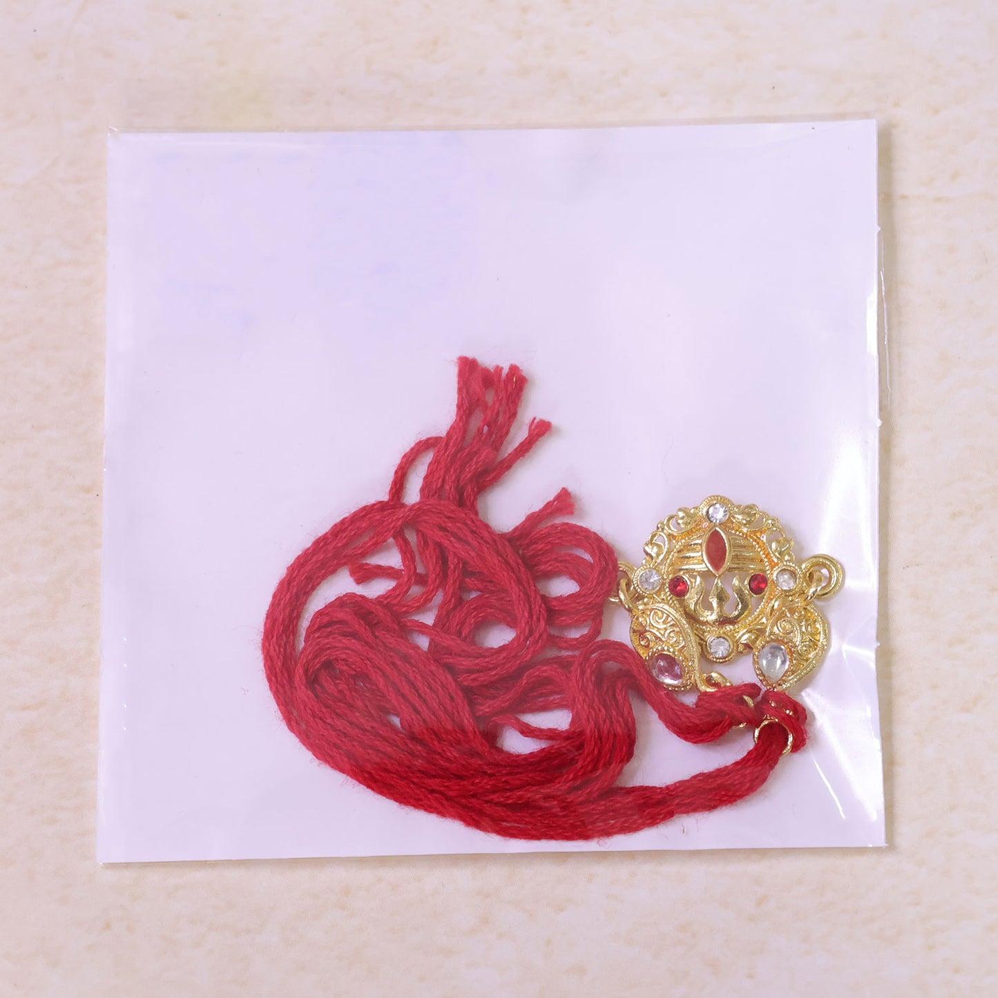 Festive Rakhi featuring Ornate Floral Medallion, pearl accents and bead line for Gift
