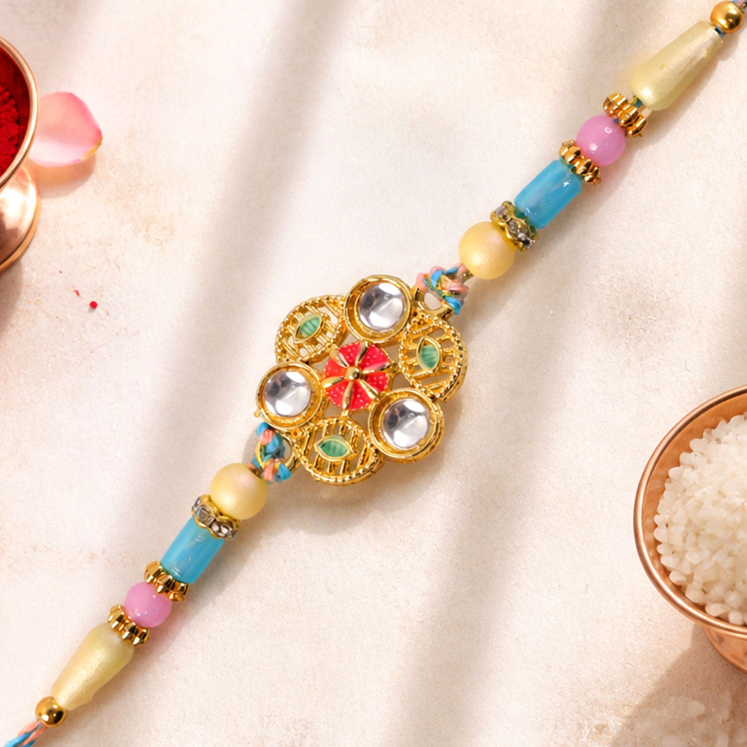 Blue Pink Floral Rakhi with Gold Medallion and Soft Festive Brother Gift Styling