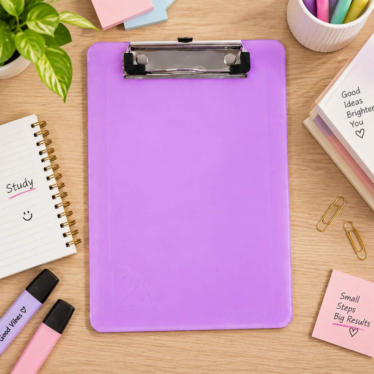 A vibrant purple plastic clipboard with a shiny metal clip rests on a wooden desk surrounded by office supplies.