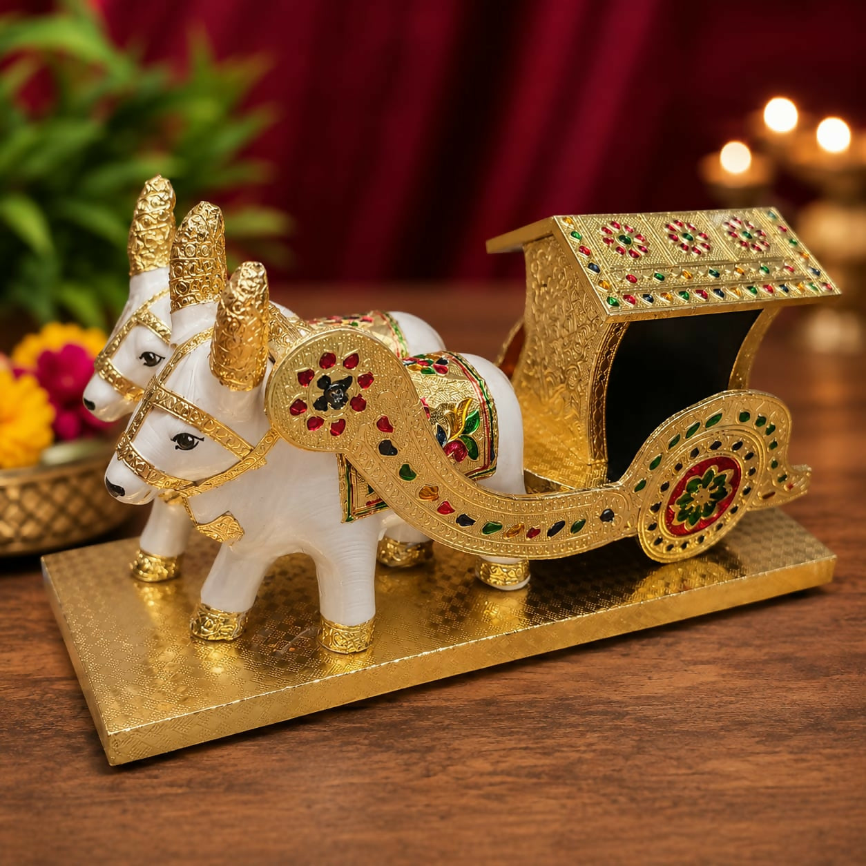 Side view of colorful Meenakari bullock cart with oxen figures