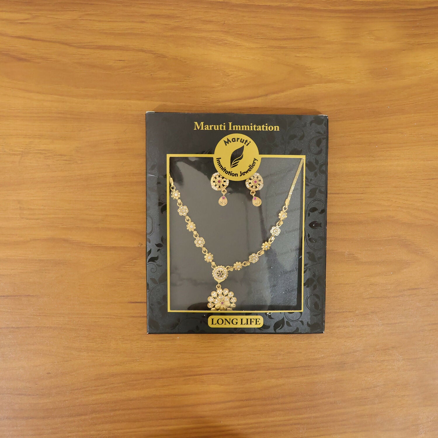 Styled view of the gold-tone floral cluster necklace with matching chain