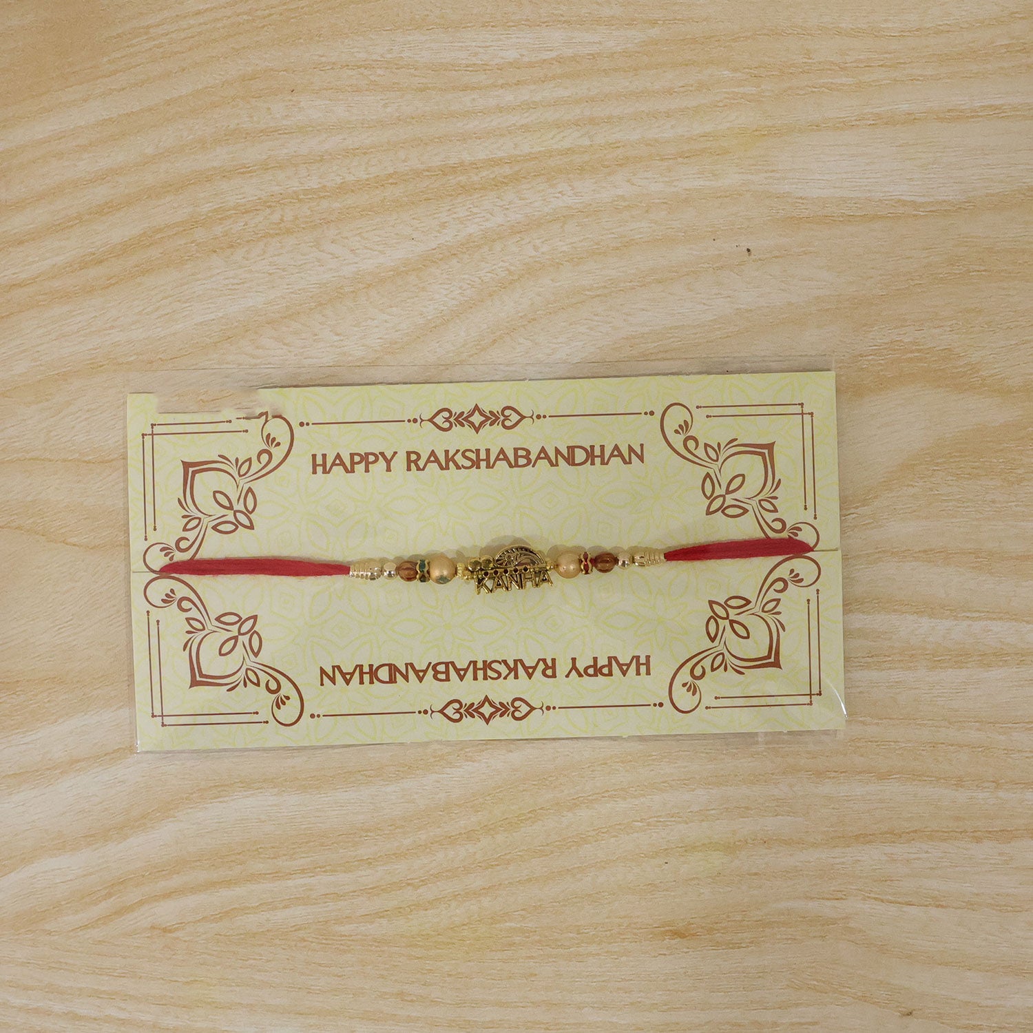 Kanha Krishna Devotional Rakhi with Peacock-Flute Style Golden Centre and Red Beads