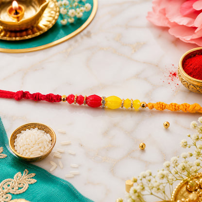 Red Thread Rakhi with Yellow and Orange Bead Pendant Accents