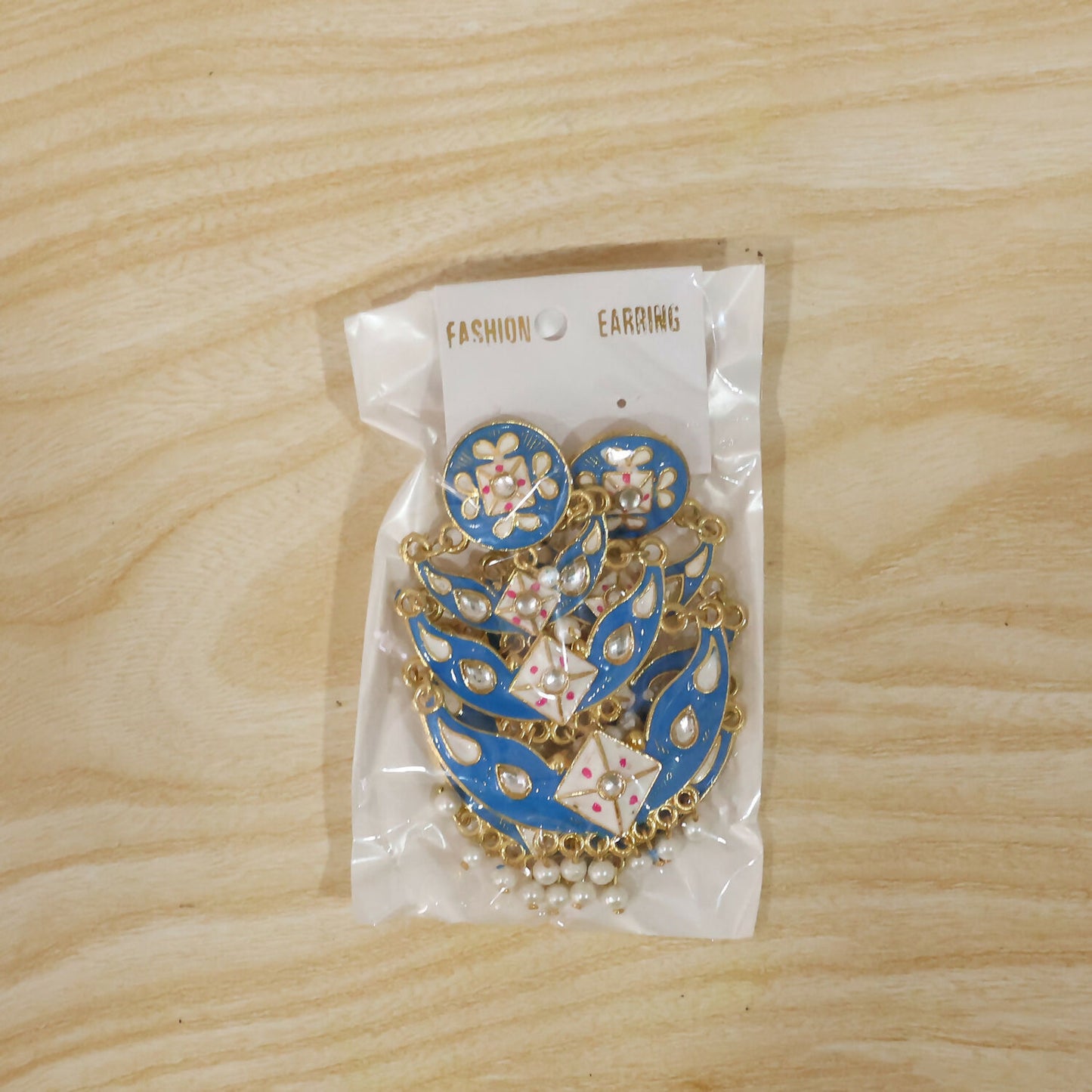 Model wearing royal blue layered pearl ethnic earrings