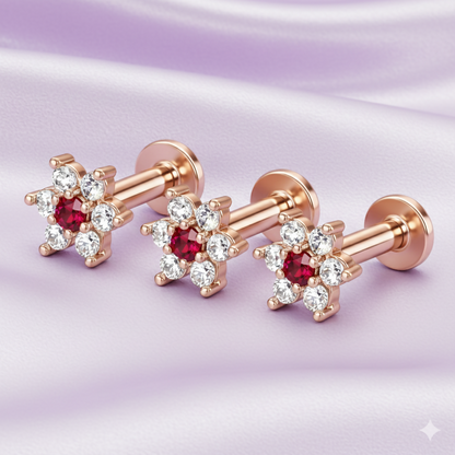 Detailed view of ruby center and diamond petals in rose gold floral studs