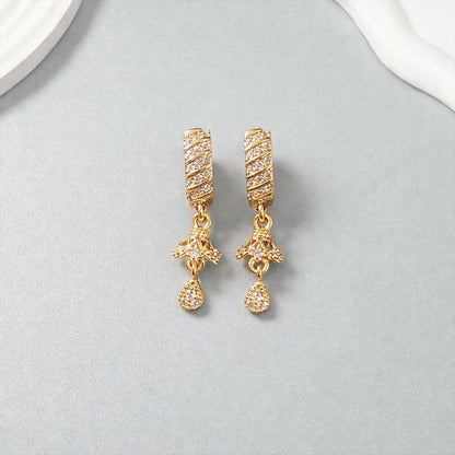 Close-up of elegant spiral bar design with shimmering crystals on dangle earrings