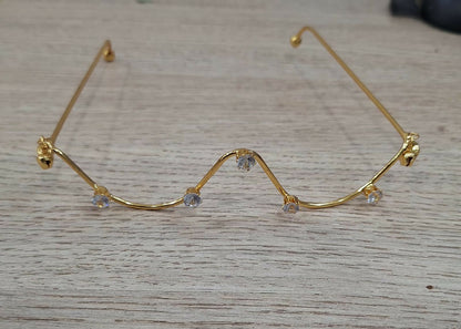 Stylish gold plated zigzag crystal goggles on white background