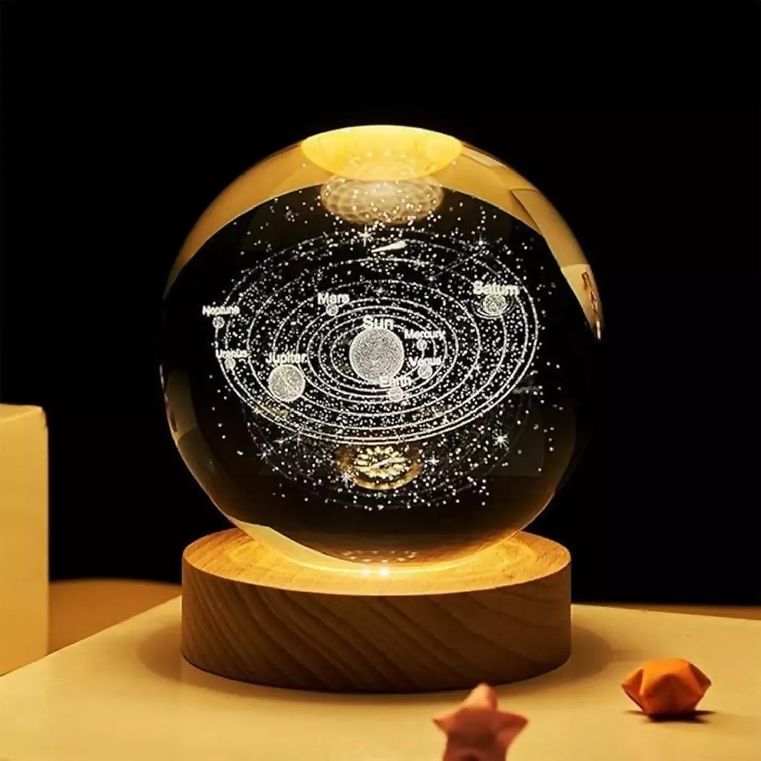 Crystal ball night lamp glowing softly with wooden base