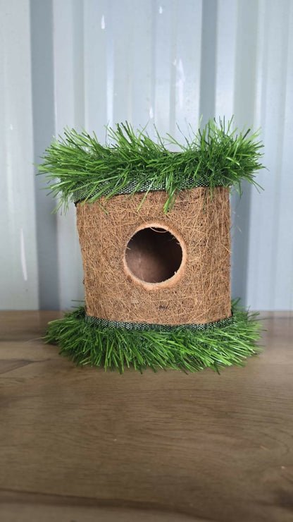 Bird house nestled in tree branches, blending with nature