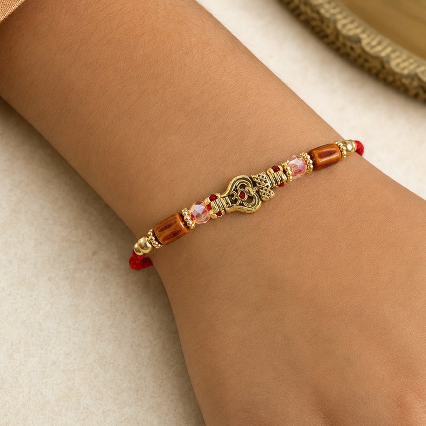 Red Thread Rakhi with Amber Beads and Antique Gold Lantern Charm