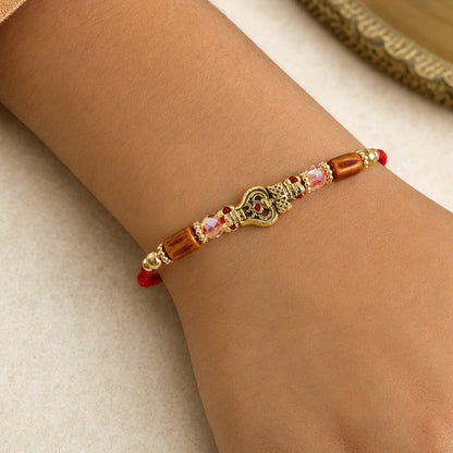 Red Thread Rakhi with Amber Beads and Antique Gold Lantern Charm