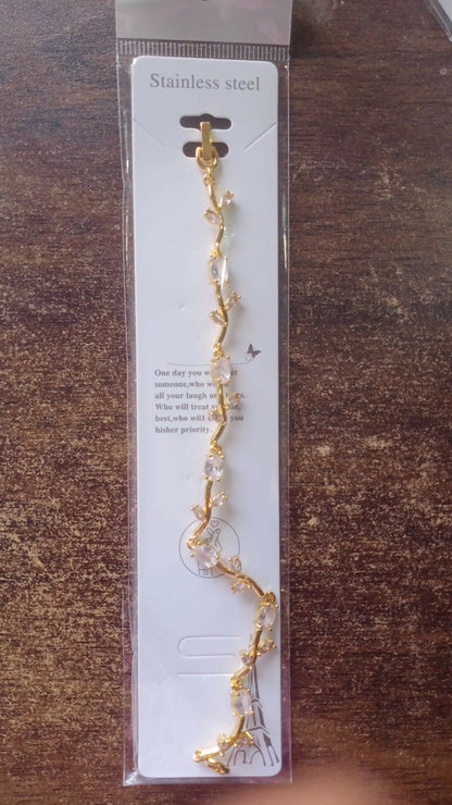 Model wearing gold-plated tulip lava stone crystal vine bracelet
