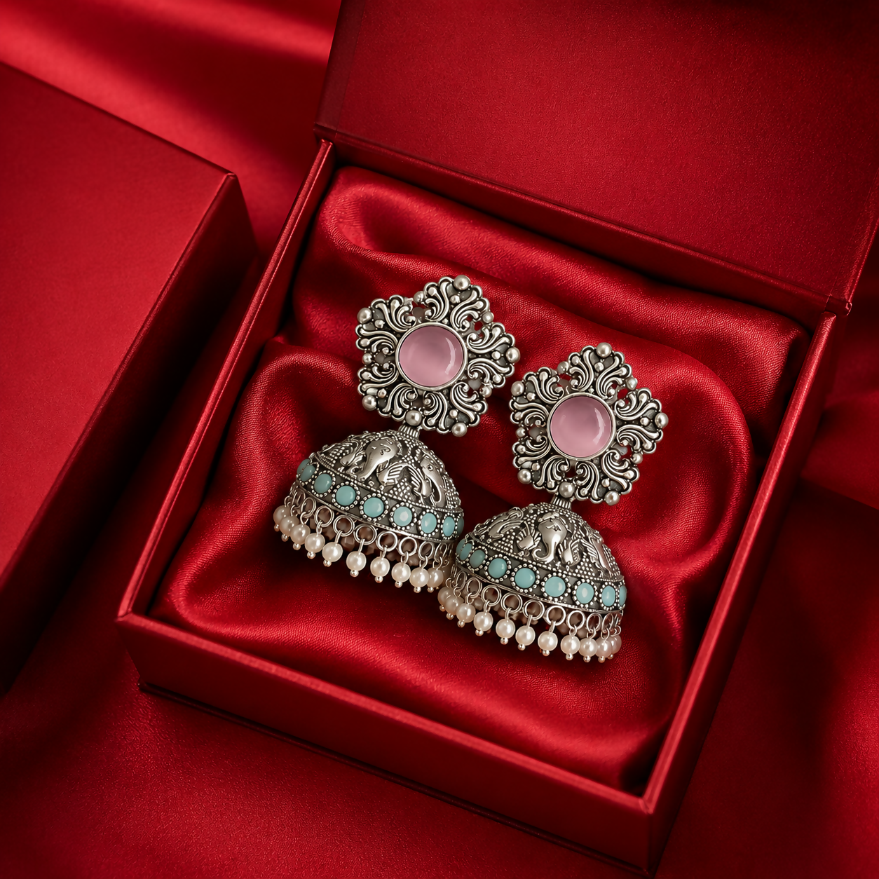 Women's oxidized silver jhumka earrings with pink stone and turquoise beads front view