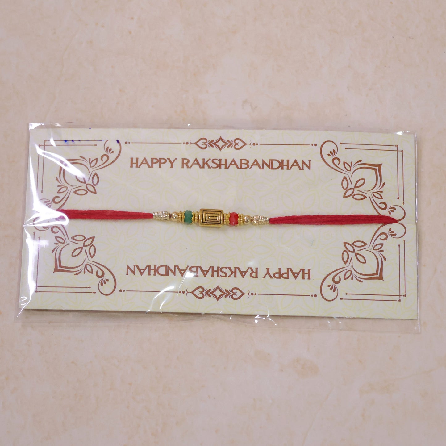Red Thread Rakhi with Carved Golden Rectangular Charm Pendant