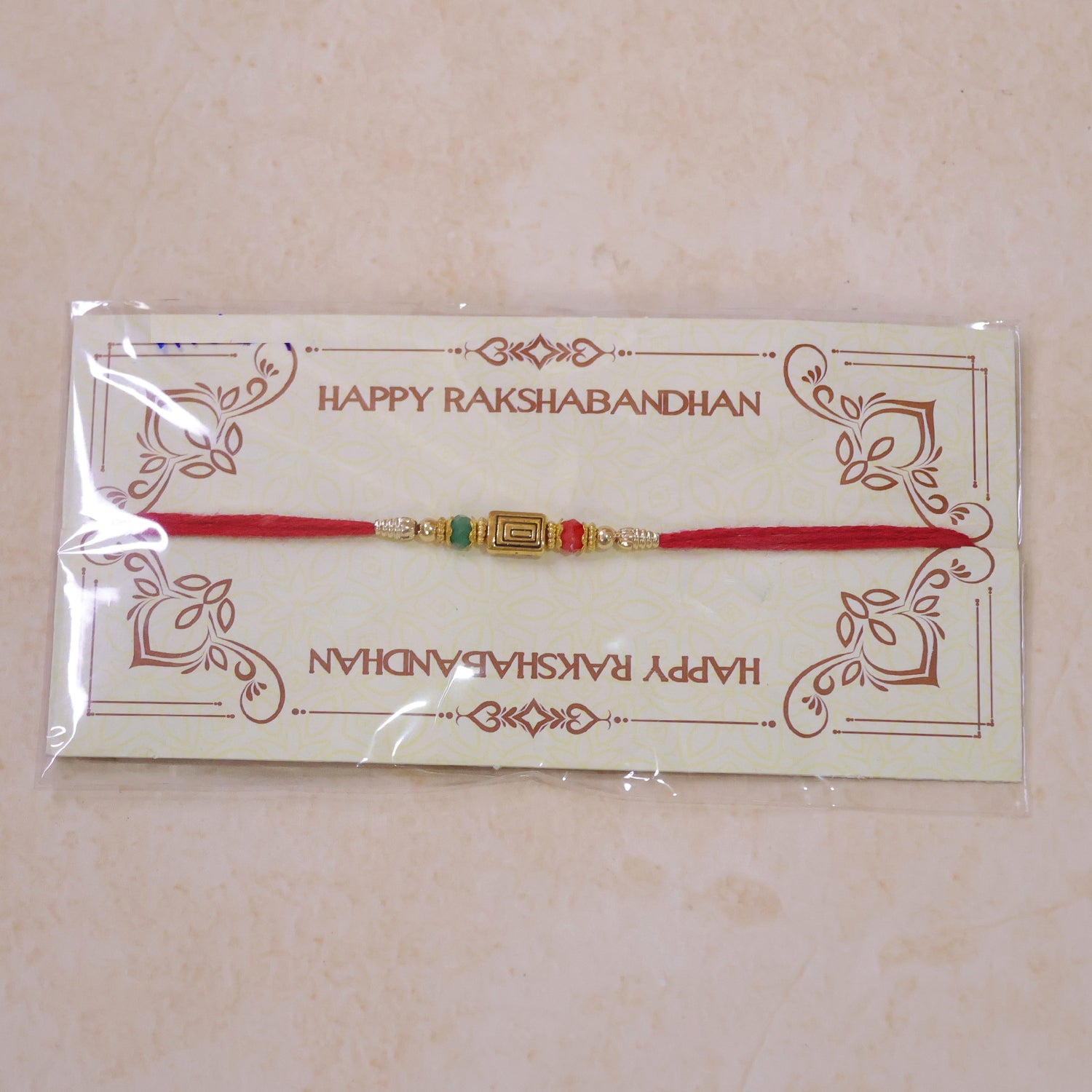 Red Thread Rakhi with Carved Golden Rectangular Charm Pendant