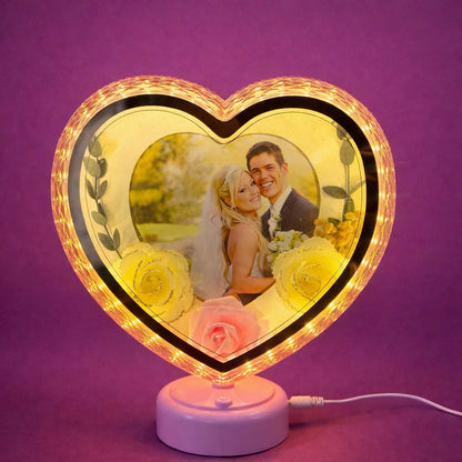 Close-up of heart-shaped LED photo frame with floral accents