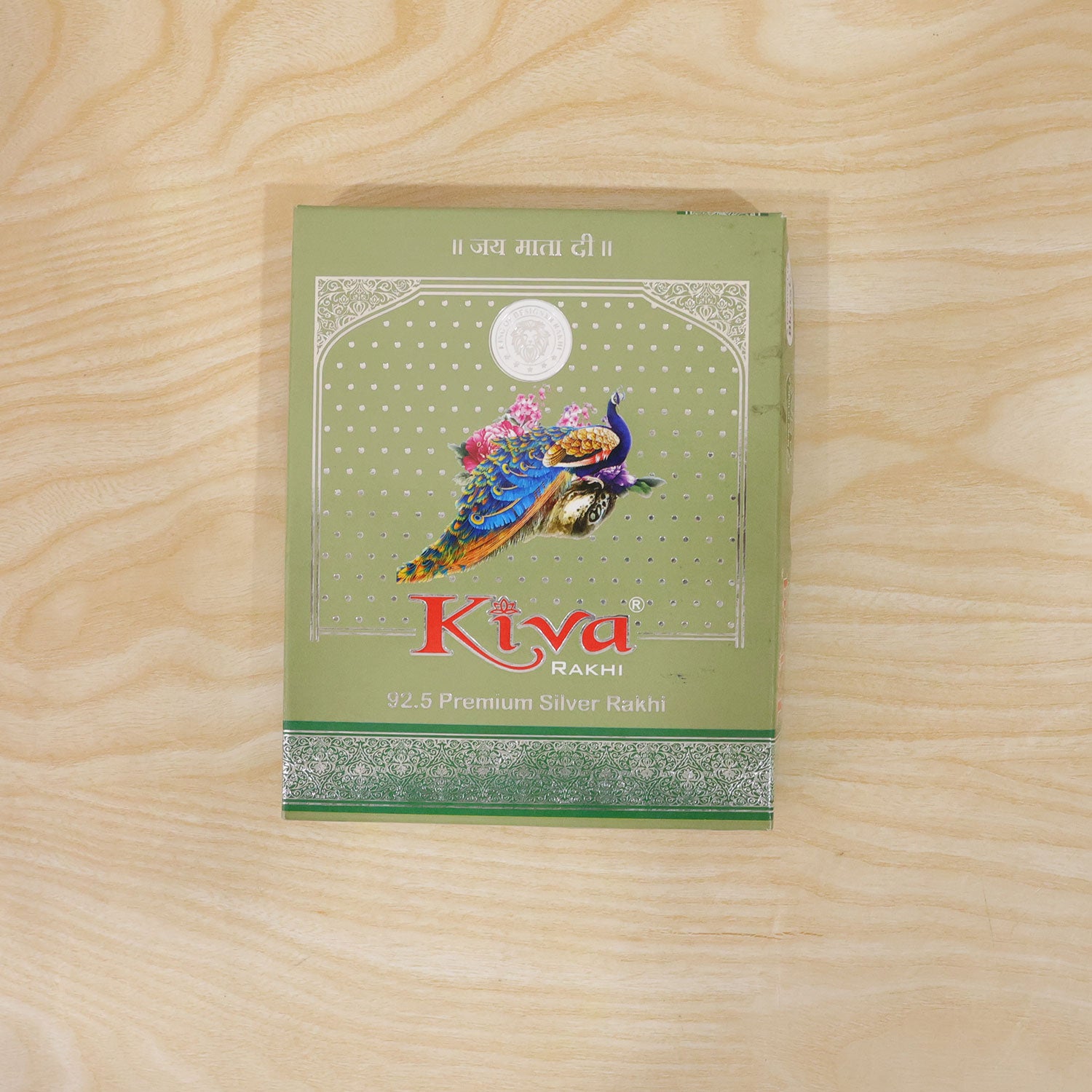 Silver Rakhi with Golden Square Om Centre, Roli Chawal Coin and Peacock Gift Packing