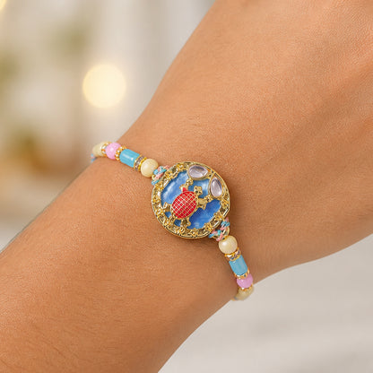 Elegant Blue Designer Rakhi for Brother with Golden Pendant & Premium Bead Work